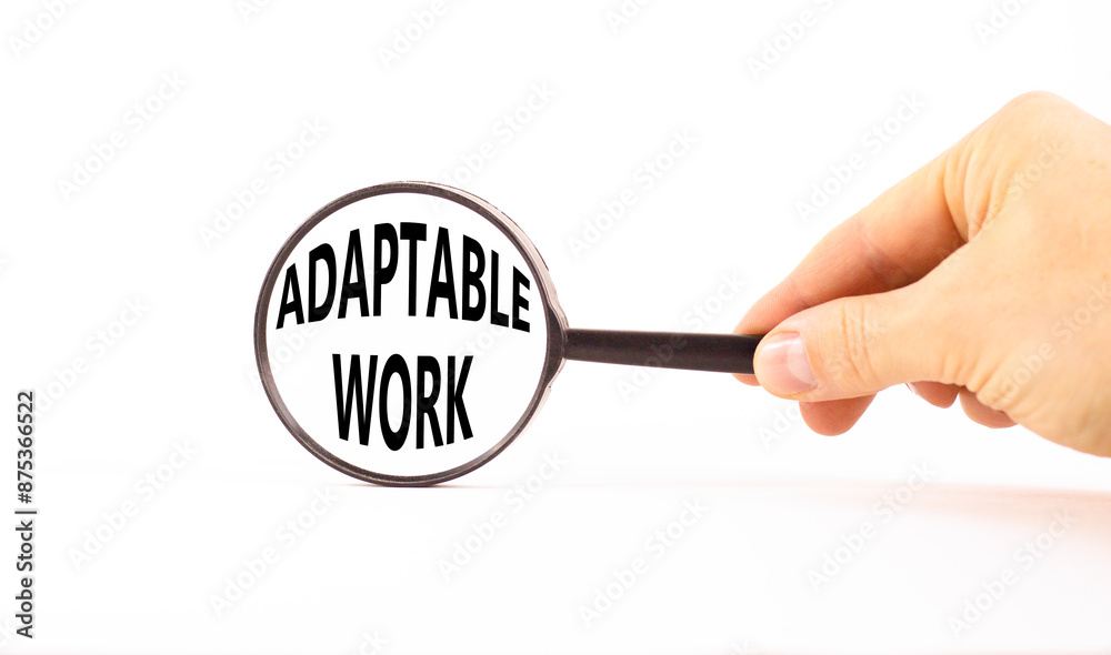 Adaptable work symbol. Concept words Adaptable work in beautiful magnifying glass. Beautiful white paper background. Businessman hand. Business Adaptable work concept. Copy space. Adaptable work symbol. Concept words Adaptable work in beautiful magnifying glass. Beautiful white paper background. Businessman hand. Business Adaptable work concept. Copy space.