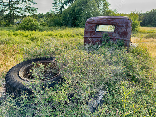 Rusting Old Truck With Tire photo