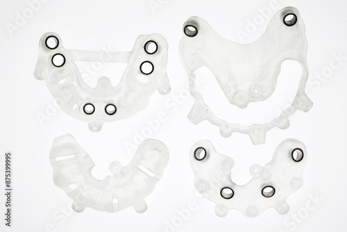 disassembled dental templates for total implantation, shot from above on a white background