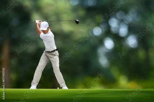 Golfer driver back swing before hitting golf ball. photo