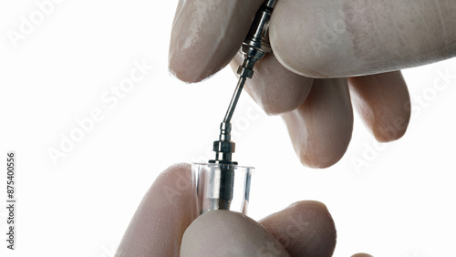 surgeon implantologist takes out an implant on a white background photo