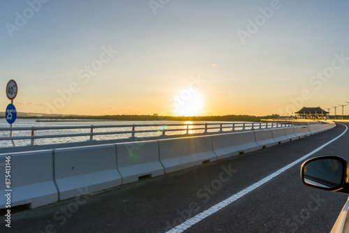 Asphalt road and beach at sunset. Road and beach background