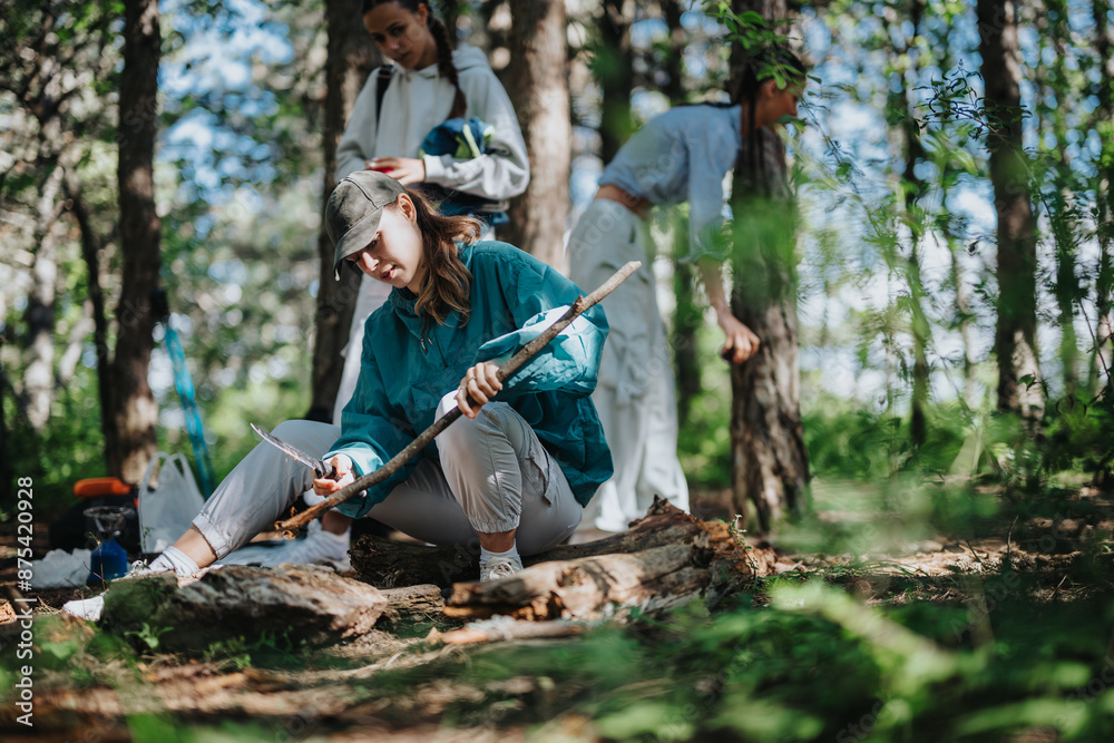 Fototapeta premium Group of friends embraced in an outdoor camping adventure, carving wood and bonding in a serene forest setting.
