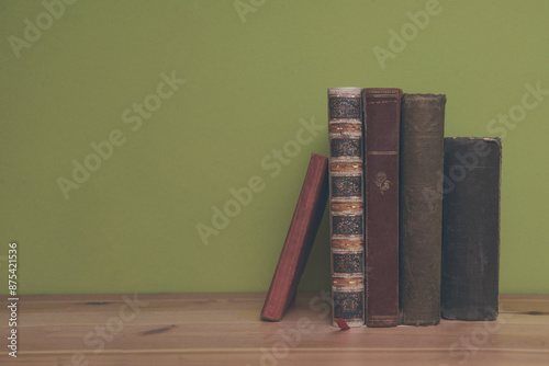 Stack of books on wooden shelf