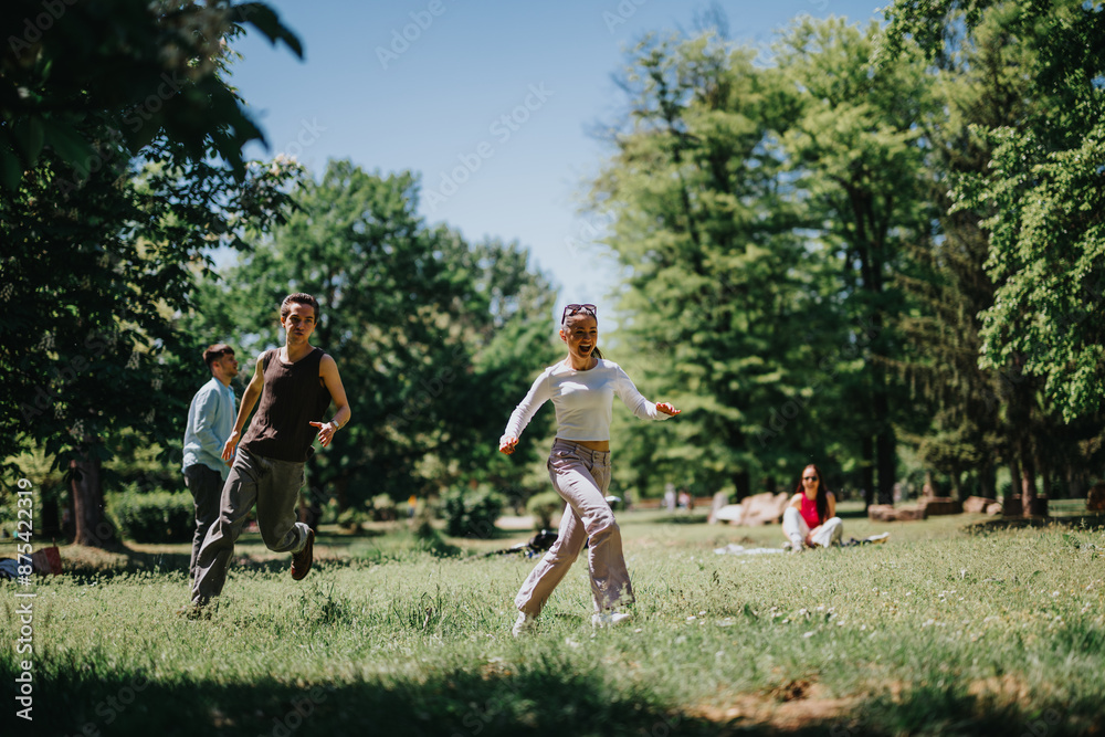 Group of friends enjoying a sunny day, chasing and playing in a lush park Group of friends enjoying a sunny day, chasing and playing in a lush park