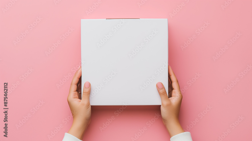 Human hands gently holding a blank cardboard box as a product packaging mockup for graphic designers. Company branding template. Human hands gently holding a blank cardboard box as a product packaging mockup for graphic designers. Company branding template.