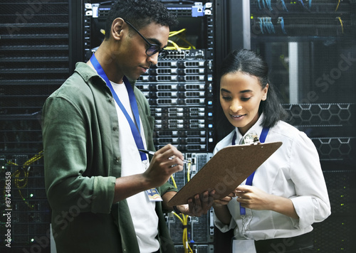 Computer center, team and data engineer with checklist, collaboration and people as programmer. Technician, clipboard and hardware security in server room for system update, analytics or maintenance photo