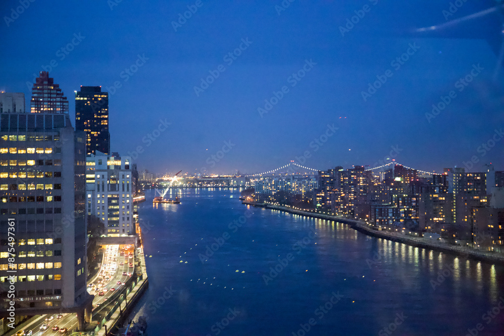 Naklejka premium New York City, New York, USA - Drone view of the East River, Roosevelt Island, the FDR drive with the Triboro Bridge in the distance