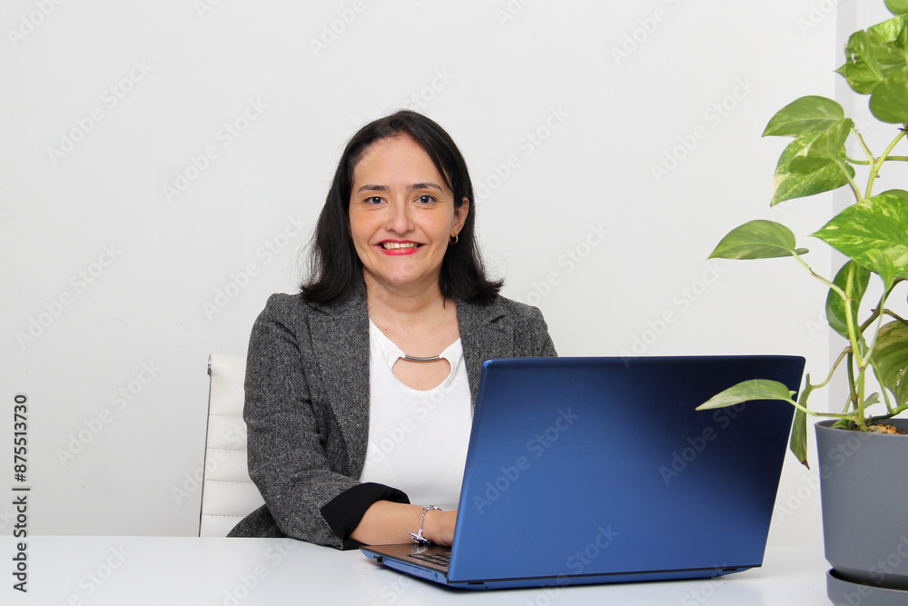 40-year-old woman works in the office with a laptop as an administration and sales professional for customer service 40-year-old woman works in the office with a laptop as an administration and sales professional for customer service
