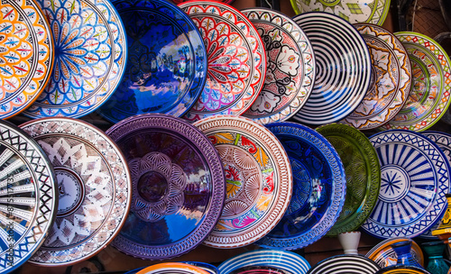 Traditional arabic handmade colorful decorated plates at a market in Marrakech, Morocco, Africa.
