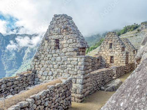 Remaining Incan Stone walls of houses in ancient lost city of Machu Picchu.