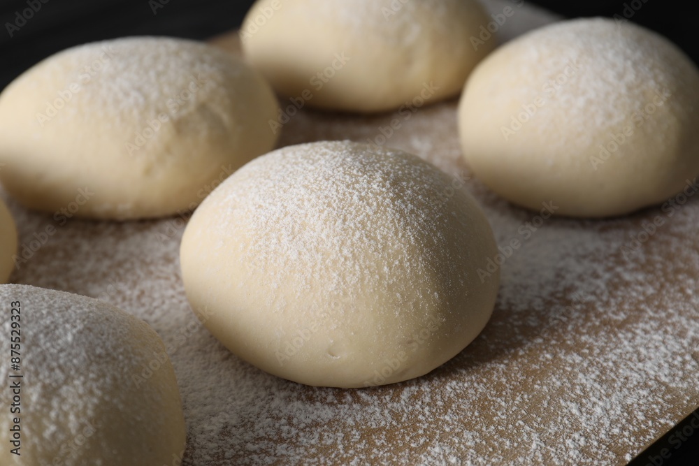 Raw dough balls with flour on table, closeup Raw dough balls with flour on table, closeup