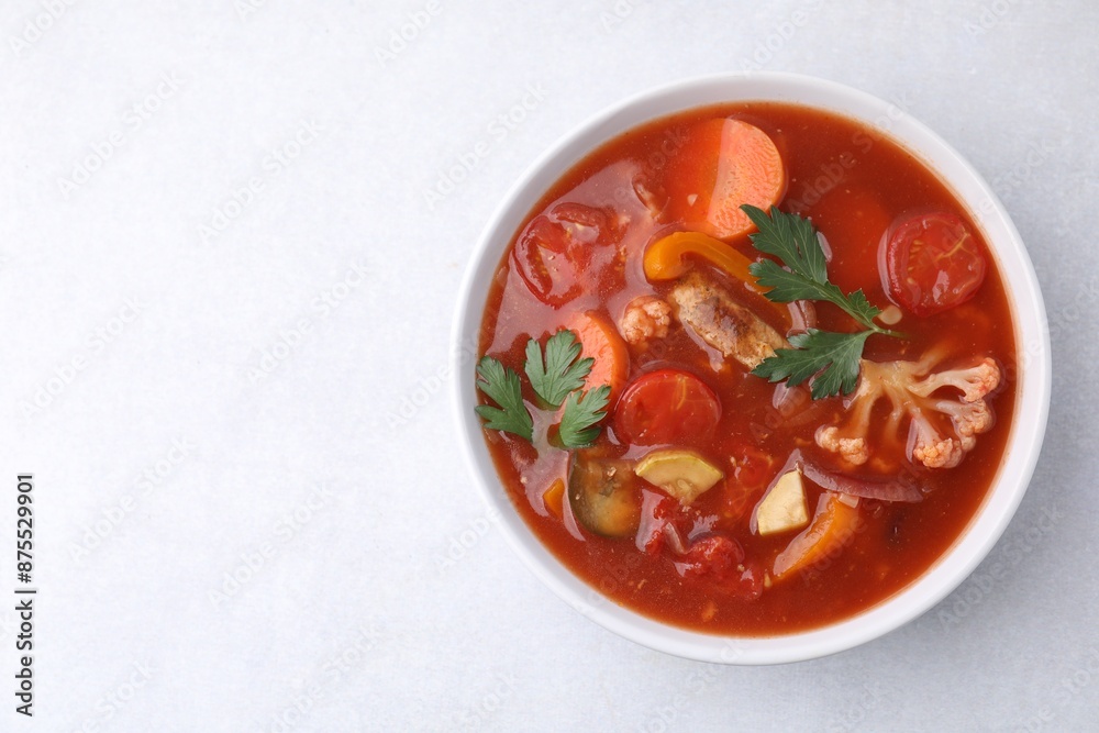 Delicious homemade stew in bowl on light table, top view. Space for text Delicious homemade stew in bowl on light table, top view. Space for text