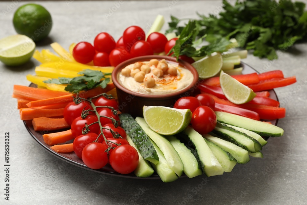 Tasty homemade hummus with chickpeas served on light grey table, closeup