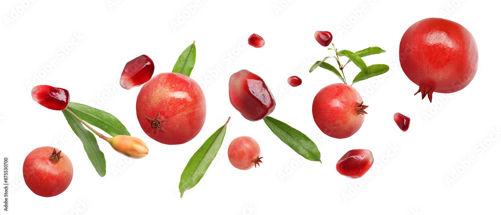 Fresh pomegranates, seeds and leaves in air on white background Fresh pomegranates, seeds and leaves in air on white background