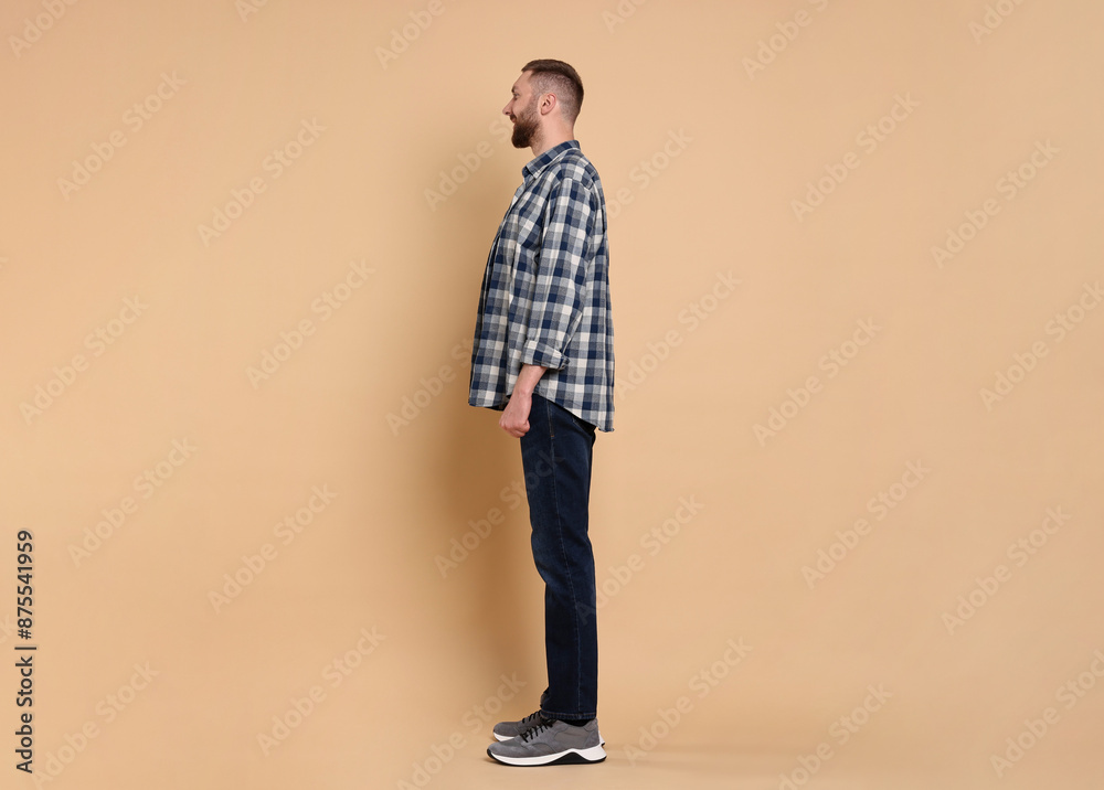Fototapeta premium Man with good posture on pale orange background