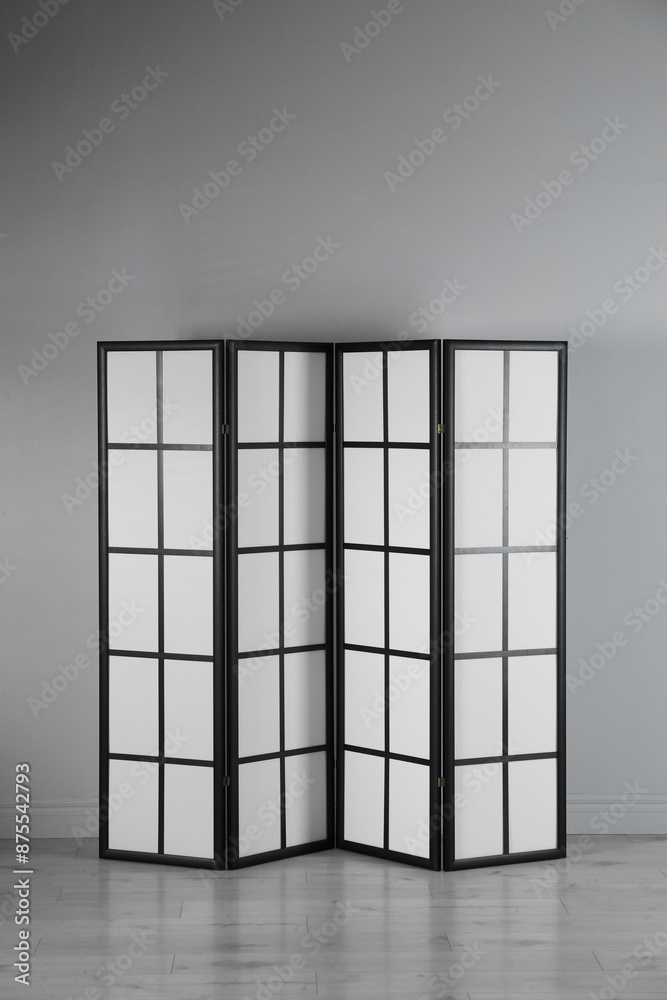 One folding screen near white wall indoors One folding screen near white wall indoors