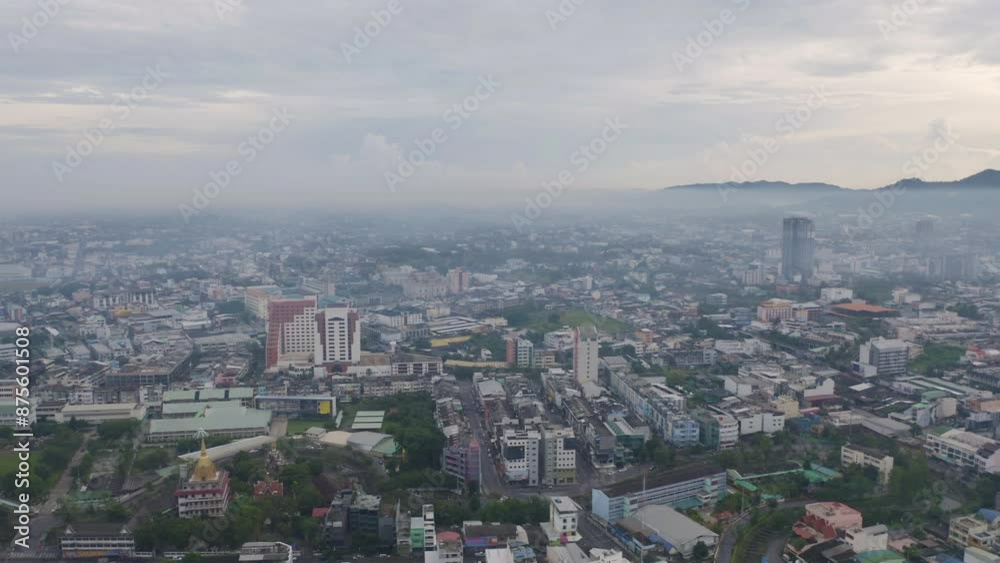 Aerial view of residential neighborhood roofs with fog mist in rainy season. Urban housing development from above. Top view. Real estate in Phuket, southern province city, Thailand. Aerial view of residential neighborhood roofs with fog mist in rainy season. Urban housing development from above. Top view. Real estate in Phuket, southern province city, Thailand.