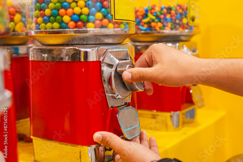 Obraz na płótnie Hands receiving gumballs from a gumball machine, with the palm open to receive
