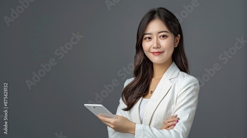 Asian male executive with beatiful hair She smiled brightly and confidently stood with her arms crossed. She wore a white suit. and stand to take pictures with a gray scene - generative ai