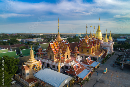 Panoramic view of thai temple with historic architecture, river, and skyline under a clear sky