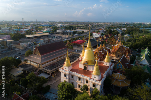Panoramic view of thai temple with historic architecture, river, and skyline under a clear sky