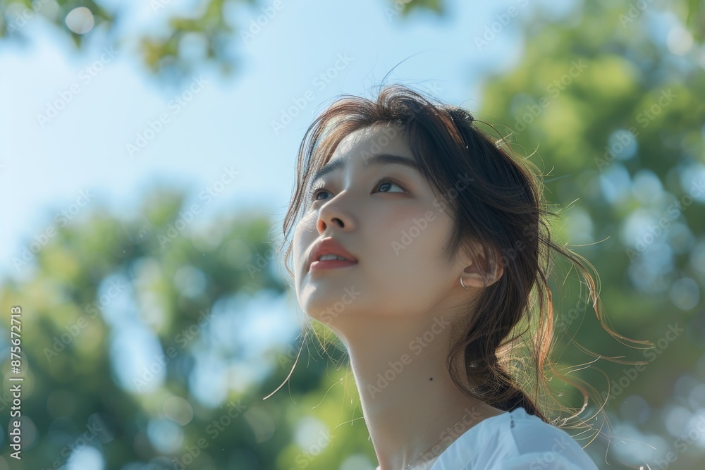 portrait asian woman white shirt side view looking at sky, outdoors with trees in the background portrait asian woman white shirt side view looking at sky, outdoors with trees in the background
