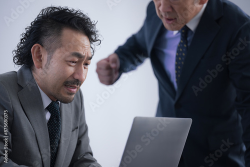 Obraz na plátně Poor businessman, stressed out and stuffed by an ogre of a boss who harasses him
