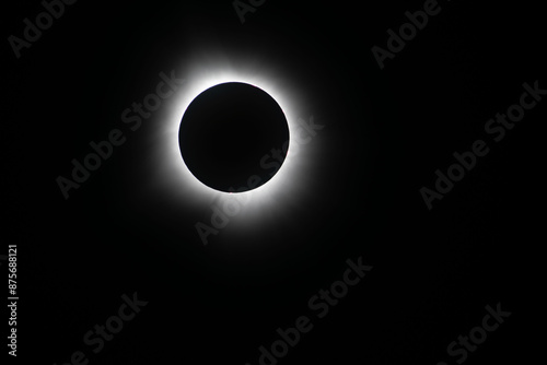 Light shining from sun around the moon creating a halo effect during the total eclipse