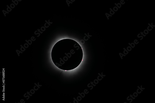 Corona surrounding the total eclipse with sun spots around the moon