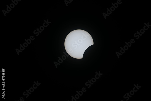 Total eclipse waxing as moon begins to cover the sun
