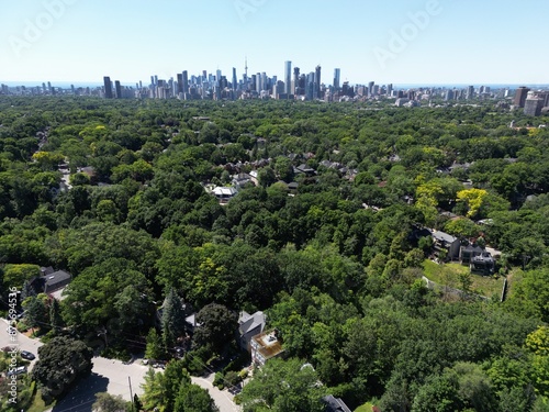 Photography View of the Toronto Skyline from the north, with an ocean of greenery in the foreground and Lake Ontario in the background
