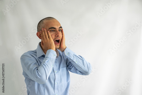 Surprised and shocked businessman with his hands on his face