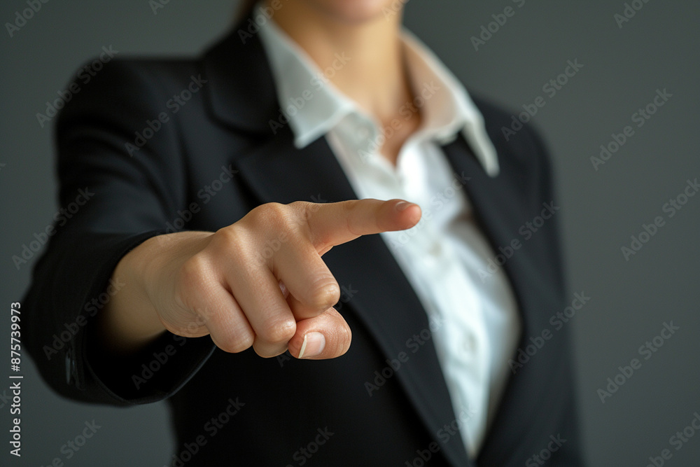 Fototapeta premium Front-facing, a businesswoman points to an empty area with his finger