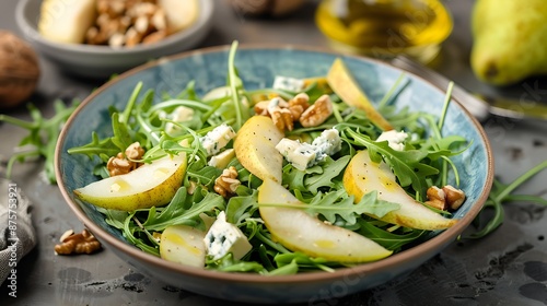 Salad with arugula fresh pear nuts and gorgonzola cheese with olive oil in a bowl healthy food concept