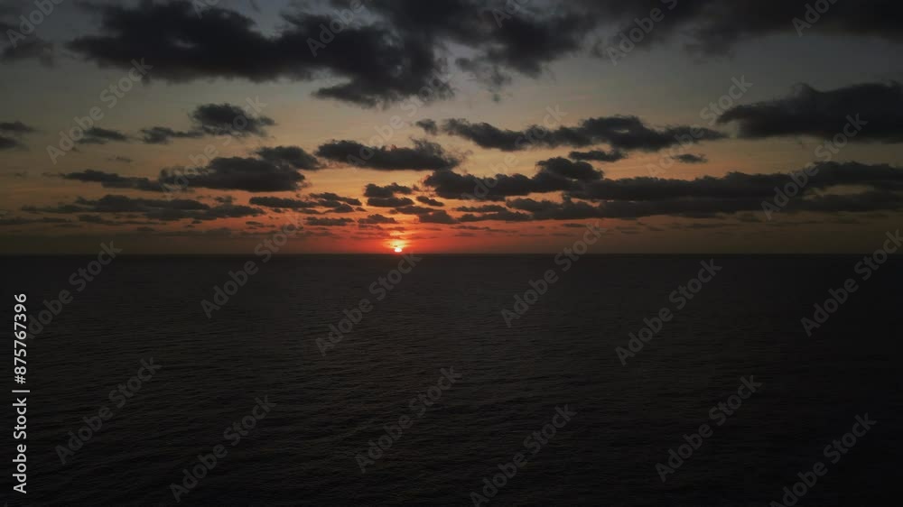 Aerial Forward Beautiful Shot Of Wavy Seascape Against Sun Under Dramatic Clouds During Sunset - Tofo Beach, Mozambique Aerial Forward Beautiful Shot Of Wavy Seascape Against Sun Under Dramatic Clouds During Sunset - Tofo Beach, Mozambique