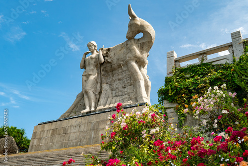 China Hainan island, Sanya city symbol, girl and the deer turning his head photo