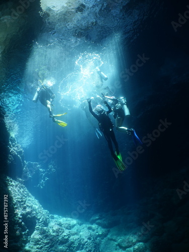Wallpaper Mural cave diving underwater  ocean scenery sun beams and rays background scuba divers to explore Torontodigital.ca