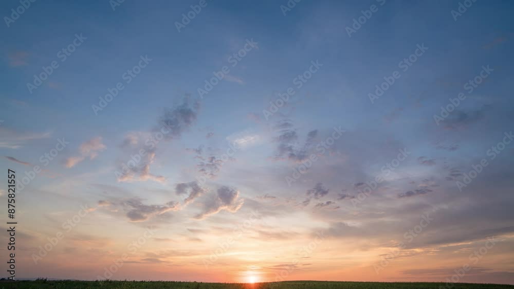 Time lapse of cloudy sky at golden sunset hour from high viewpoint over plain area