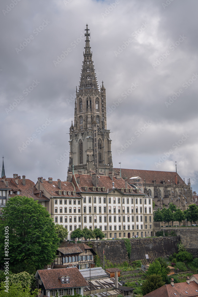 Naklejka premium tourist go to travel walk in walking street see old building architecture nation flag and clock tower in Bern Switzerland spring season