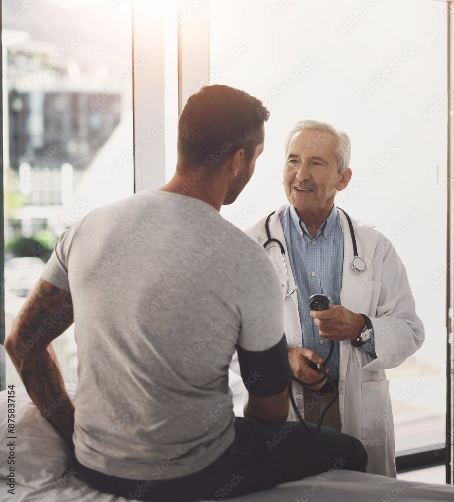 Doctor, patient and man for blood pressure in healthcare with test for hypertension and happy with wellness check. Medical professional, person and consultation for vital signs and health assessment Doctor, patient and man for blood pressure in healthcare with test for hypertension and happy with wellness check. Medical professional, person and consultation for vital signs and health assessment