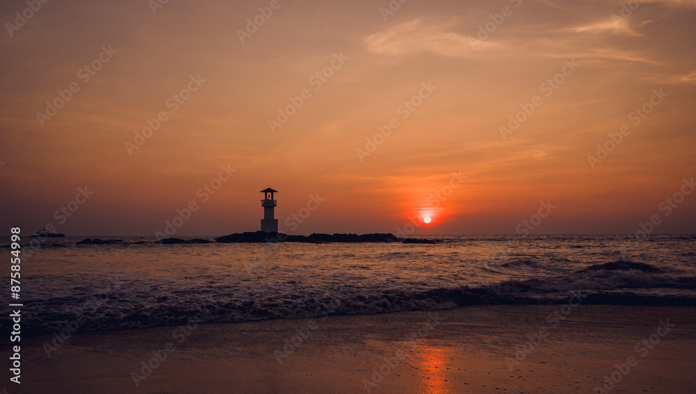 A lighthouse in the ocean during a beautiful sunset A lighthouse in the ocean during a beautiful sunset
