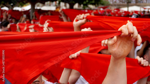 Quadro su tela People hold red scarves with their hands raised