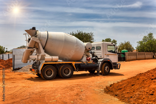 Konstfotografi concrete mixer trucks on a dirt road on construction site
