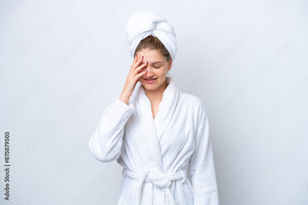 Teenager Russian girl in a bathrobe isolated on white background laughing Teenager Russian girl in a bathrobe isolated on white background laughing