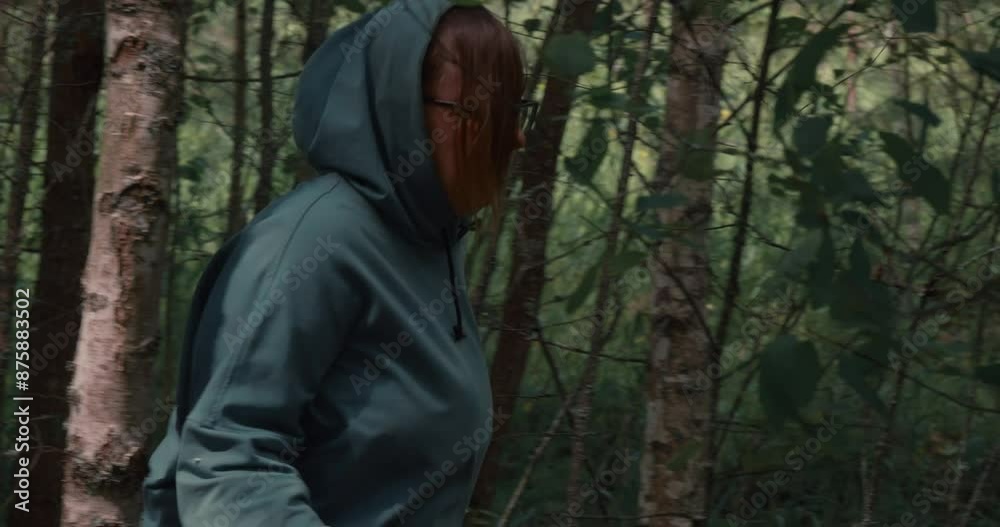 Making her way through a dense forest, exhausted from a long pursuit, the frightened woman continues to run with all her might. The woman runs in fear, making her way through the trees and branches. Making her way through a dense forest, exhausted from a long pursuit, the frightened woman continues to run with all her might. The woman runs in fear, making her way through the trees and branches.