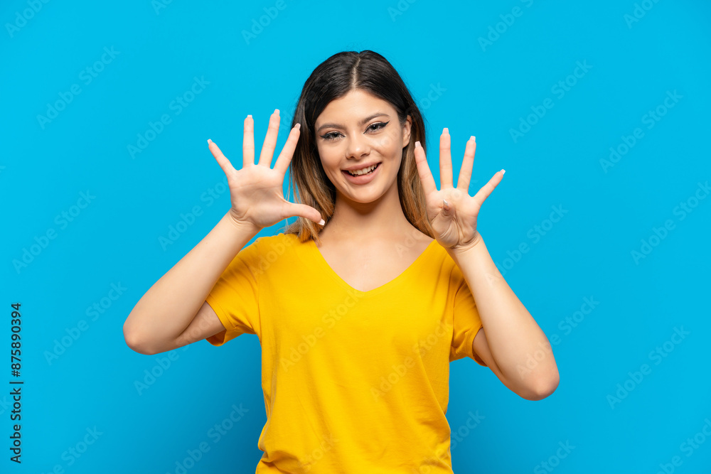 Young Russian girl isolated on blue background counting nine with fingers Young Russian girl isolated on blue background counting nine with fingers