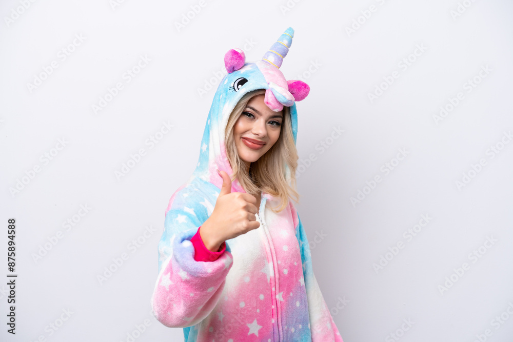 Young Russian woman with unicorn pajamas isolated on white background with thumbs up because something good has happened Young Russian woman with unicorn pajamas isolated on white background with thumbs up because something good has happened