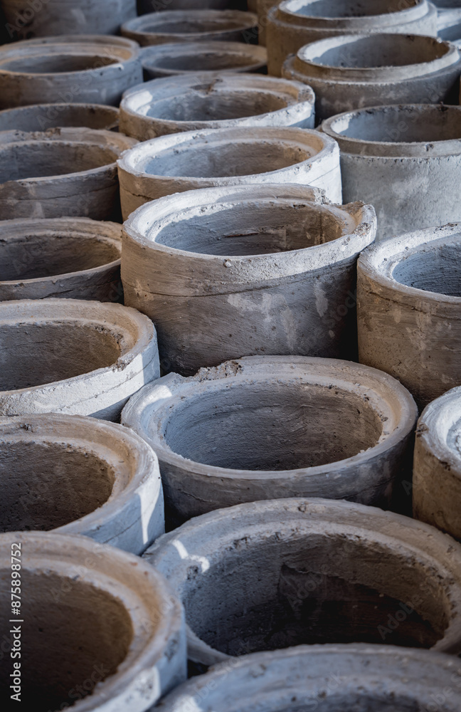 A stack of concrete ring pipes piled and creating a symmetrical arrangement A stack of concrete ring pipes piled and creating a symmetrical arrangement