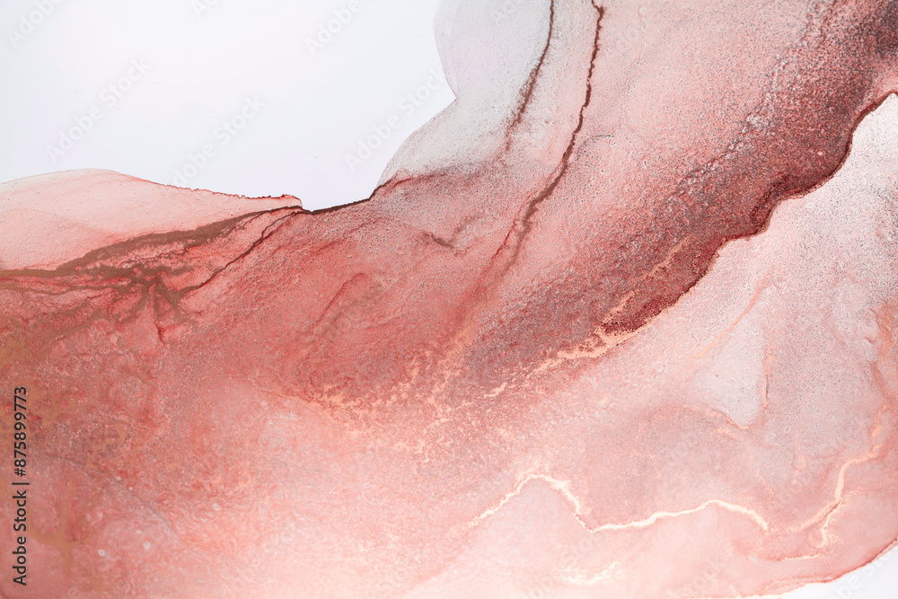 Fototapeta premium A close-up shot of abstract art created with pink and copper ink on a white background. The ink swirls and blends in a mesmerizing pattern